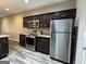 Kitchen featuring stainless steel appliances, dark cabinetry, and granite countertops at 1853 Broad River Rd, Atlanta, GA 30349
