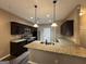 A modern kitchen features granite counters, stainless appliances, and dark wood cabinets at 1853 Broad River Rd, Atlanta, GA 30349