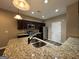 A kitchen features granite counters, stainless appliances, and dark wood cabinets at 1853 Broad River Rd, Atlanta, GA 30349