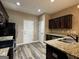 Kitchen showcasing dark cabinets, granite countertops, and stainless steel appliances with great natural light at 1853 Broad River Rd, Atlanta, GA 30349