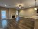 Large living room with a fireplace, ceiling fan and view into the kitchen at 1853 Broad River Rd, Atlanta, GA 30349