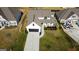Aerial view of a two-story home with a manicured lawn and dark garage door at 15 Dayton Way, Sharpsburg, GA 30277