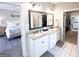 Beautiful bathroom with double vanity, granite countertops, and serene lighting leading to bedroom and closet at 15 Dayton Way, Sharpsburg, GA 30277
