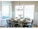 Sunlit dining room with modern chandelier and seating for eight at 15 Dayton Way, Sharpsburg, GA 30277
