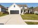 Beautiful exterior view of a two story home with a large black garage door and landscaped front yard at 15 Dayton Way, Sharpsburg, GA 30277