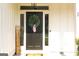 Close-up of a charming front door adorned with a welcoming wreath at 15 Dayton Way, Sharpsburg, GA 30277