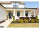 Inviting front porch with a charming wreath on the front door and lovely landscaping at 15 Dayton Way, Sharpsburg, GA 30277
