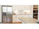Bright kitchen boasts stainless steel appliances, granite counters, and white cabinets at 15 Dayton Way, Sharpsburg, GA 30277