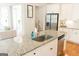 Modern kitchen island with granite countertop, stainless steel appliances, and white cabinets at 15 Dayton Way, Sharpsburg, GA 30277