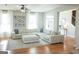 Bright living room with hardwood floors and a comfortable sectional sofa at 15 Dayton Way, Sharpsburg, GA 30277