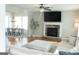 Inviting living room features a stone fireplace, ceiling fan, and views of the dining area at 15 Dayton Way, Sharpsburg, GA 30277