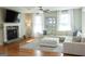 Comfortable living room featuring a stone fireplace, natural light, and an inviting sectional sofa at 15 Dayton Way, Sharpsburg, GA 30277
