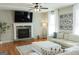 Cozy living room with stone fireplace, large TV, and comfortable sectional at 15 Dayton Way, Sharpsburg, GA 30277