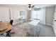 Bright home office with two white modern desks, a stylish rug, and natural light from a window at 15 Dayton Way, Sharpsburg, GA 30277