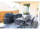 Covered patio with outdoor dining furniture, including a table and chairs, and two grills at 15 Dayton Way, Sharpsburg, GA 30277