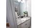 Stylish powder room featuring granite counters, decor, and a modern mirror, perfect for guests' convenience at 15 Dayton Way, Sharpsburg, GA 30277