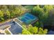 Overhead view of community tennis courts surrounded by trees and a parking area at 15 Dayton Way, Sharpsburg, GA 30277