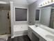 Bathroom featuring double vanity, bathtub, enclosed shower, and window at 3015 Cranbrook Nw Walk, Kennesaw, GA 30144