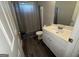 Bathroom with vinyl floors, a gray shower curtain, toilet, and vanity with sink at 3015 Cranbrook Nw Walk, Kennesaw, GA 30144