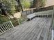 Wooden deck with white bench seating surrounded by a fenced backyard at 3015 Cranbrook Nw Walk, Kennesaw, GA 30144
