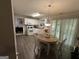 Cozy eat-in kitchen with white cabinets, appliances, a table, and deck access at 3015 Cranbrook Nw Walk, Kennesaw, GA 30144
