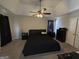 Main bedroom with dark furniture and carpet and including a closet and ceiling fan at 3015 Cranbrook Nw Walk, Kennesaw, GA 30144
