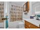 Cozy bathroom with floral shower curtain and wood vanity at 1326 Harmony Grove Church Rd, Auburn, GA 30011