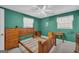 Spacious bedroom with bright green walls and hardwood furniture at 1326 Harmony Grove Church Rd, Auburn, GA 30011