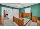 Bedroom with green walls, carpet, ceiling fan, and wood furniture, offering a cozy and inviting space at 1326 Harmony Grove Church Rd, Auburn, GA 30011