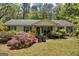 Charming ranch home with lush landscaping and a welcoming front porch at 1326 Harmony Grove Church Rd, Auburn, GA 30011