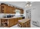 Traditional eat-in kitchen with center island, wood cabinetry, and bright natural lighting at 1326 Harmony Grove Church Rd, Auburn, GA 30011