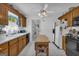 Traditional eat-in kitchen with center island, wood cabinetry, and bright natural lighting at 1326 Harmony Grove Church Rd, Auburn, GA 30011