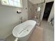 Modern bathroom showcasing a freestanding tub, glass-enclosed shower, and neutral color scheme for a spa-like feel at 2873 Shoals Hill Ct, Dacula, GA 30019