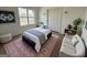 Cozy bedroom featuring a comfortable bed, stylish decor, and a window offering views of the outdoors at 2873 Shoals Hill Ct, Dacula, GA 30019