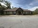 Exterior view of community clubhouse with a large parking lot and accessible access at 2873 Shoals Hill Ct, Dacula, GA 30019