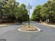 Gated community entrance featuring a solar powered security system and beautifully maintained landscaping at 2873 Shoals Hill Ct, Dacula, GA 30019
