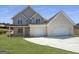 Charming two-story home featuring a two-car garage, a welcoming porch, and a neatly manicured lawn at 2873 Shoals Hill Ct, Dacula, GA 30019