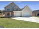 Charming two-story home featuring a two-car garage, a welcoming porch, and a neatly manicured lawn at 2873 Shoals Hill Ct, Dacula, GA 30019