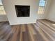 The electric fireplace in a room featuring durable flooring and windows at 2873 Shoals Hill Ct, Dacula, GA 30019
