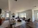 A spacious living room is furnished with modern decor, a fireplace, and large windows offering ample natural light at 2873 Shoals Hill Ct, Dacula, GA 30019