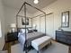 The spacious main bedroom features stylish decor, a comfortable bed, and ample natural light at 2873 Shoals Hill Ct, Dacula, GA 30019