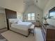The spacious main bedroom features stylish decor, a comfortable bed, and ample natural light at 2873 Shoals Hill Ct, Dacula, GA 30019