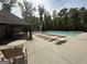 An angle view of the spacious community pool with shaded seating areas and well maintained patio at 2873 Shoals Hill Ct, Dacula, GA 30019