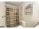 Toilet and shower behind a colorful curtain; shelf adds storage to this full bathroom at 109 Windsong Dr, Stockbridge, GA 30281