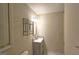 Bathroom with decorative shelving above the sink and blinds on the window at 109 Windsong Dr, Stockbridge, GA 30281