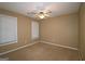 This bedroom features neutral paint, carpet, a ceiling fan, and natural light from two windows at 109 Windsong Dr, Stockbridge, GA 30281