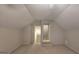 Neutral carpeted bonus room with doorway and staircase leading to another level of the house at 109 Windsong Dr, Stockbridge, GA 30281
