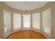 Bright breakfast nook with hardwood floors, white trim windows, and elegant chandelier at 109 Windsong Dr, Stockbridge, GA 30281