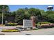 The neighborhood entrance features manicured landscaping and beautiful shrubbery at 109 Windsong Dr, Stockbridge, GA 30281