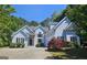 Beautiful two-story home featuring a well manicured lawn, mature trees and ample parking space in the driveway at 109 Windsong Dr, Stockbridge, GA 30281